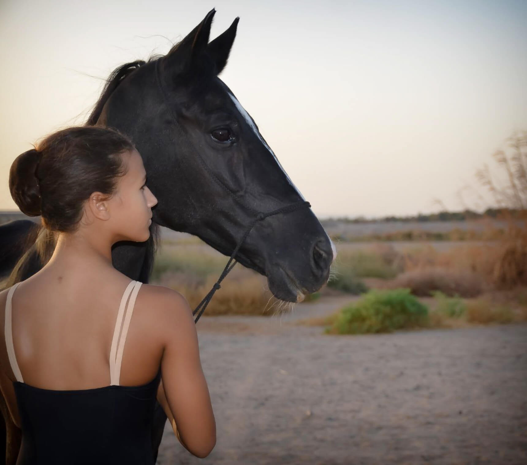 A girl with a black horse